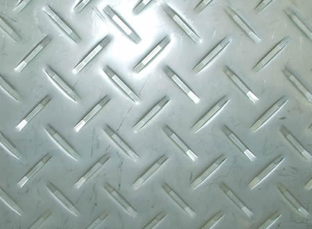 A piece of stainless steel checker plate with diamond projections.
