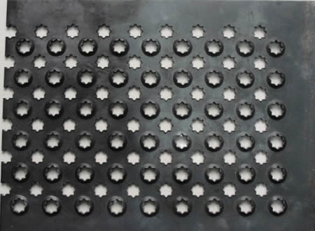 A piece of stainless steel checker plate with raised and flat projections.