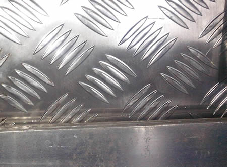 A section of aluminum stair tread.